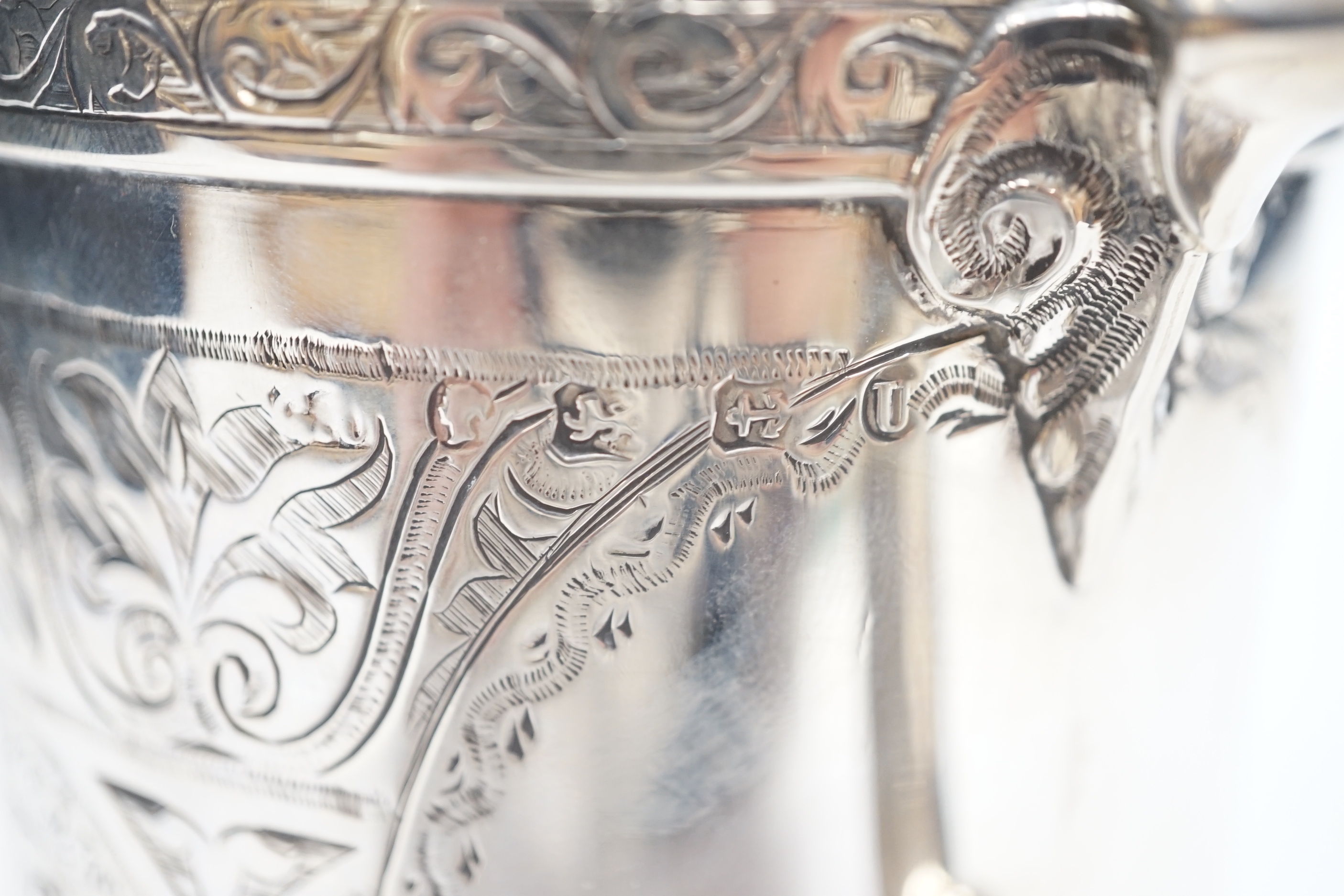 A Victorian engraved silver mug, with ornate handle, George Unite, Birmingham, 1869, height 12.4cm, 12.4oz.